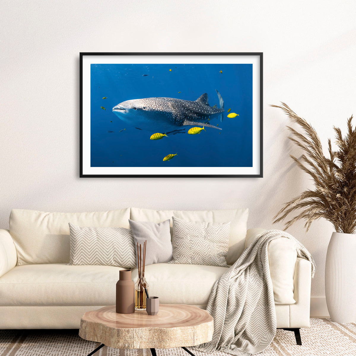 Room mockup above a sofa: Big fish little fish — whale shark accompanied by small yellow fish.