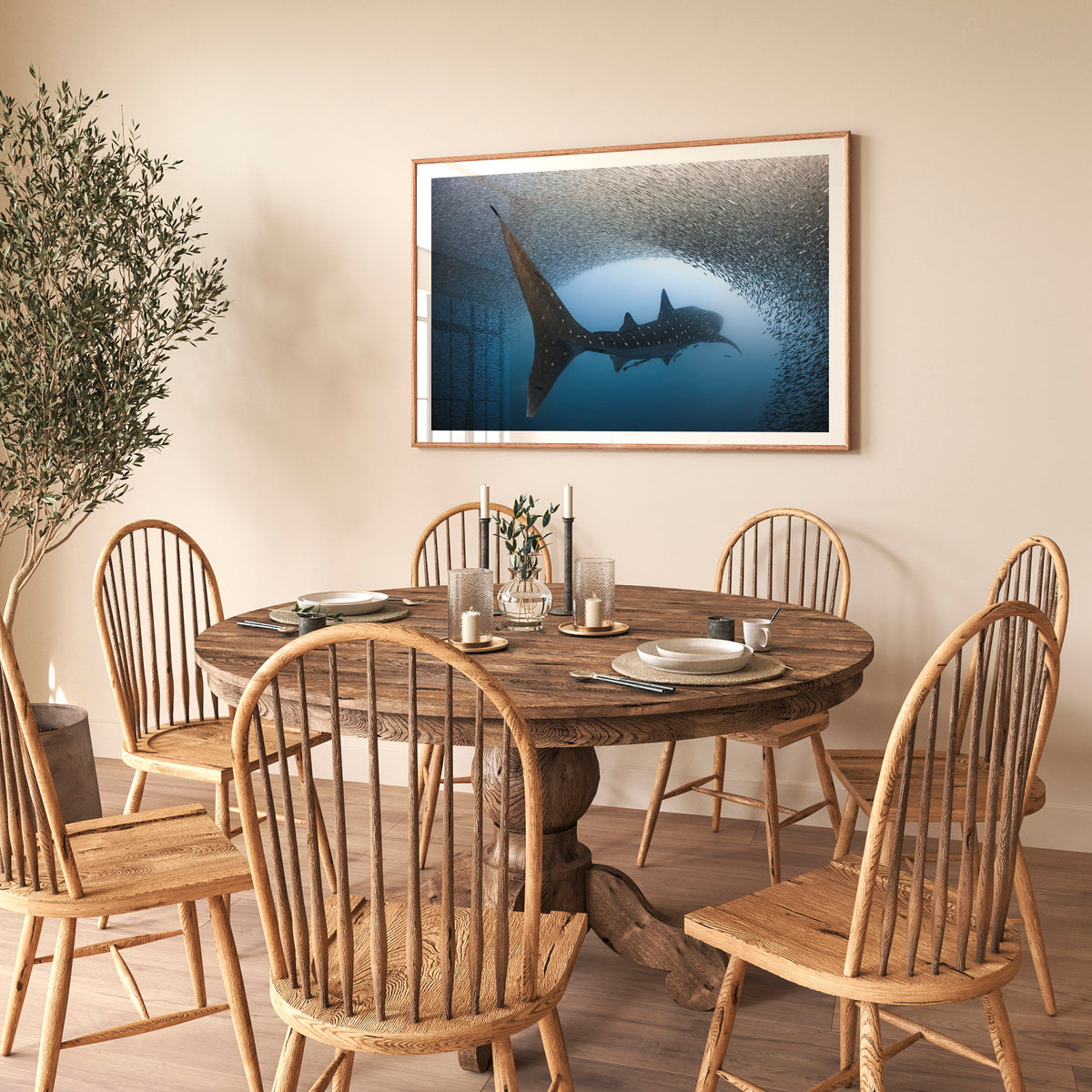 Room mockup above a dining table: Light at the end of the tunnel — whale shark passing through a dense school of fish.