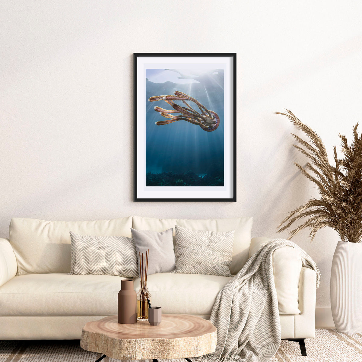 Room mockup above a sofa: Rasta jelly — jellyfish beneath shafts of sunlight.