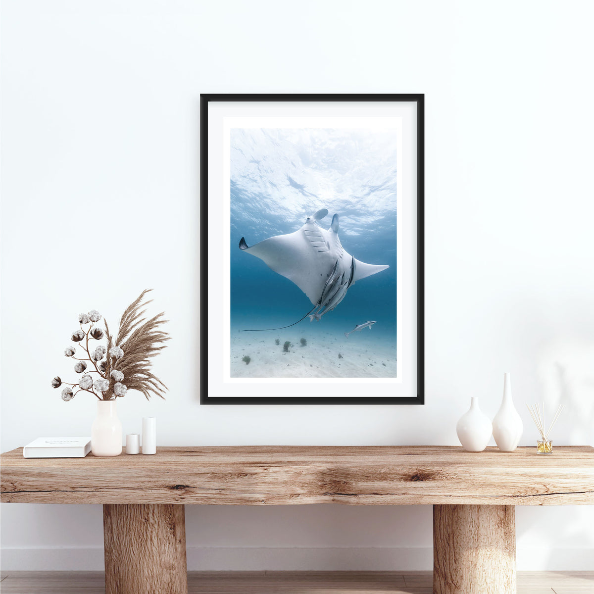Room mockup above a console table: Angel — manta ray viewed from below with accompanying fish.